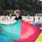 Children install a large colored canopy