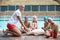 Children and instructor during rescue training at poolside