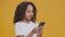 Children internet addiction. Interested african american girl browsing on smartphone, semi profile portrait