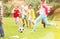 Children are jogning and playing football