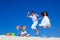 Children jumping on beach