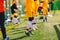 Children Jumping on Soccer Sports Training. Kids Running on Warm-up Before the Soccer Game