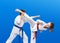 Children in karategi are training karate blows