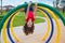 Children kid girl upside down on a park ring