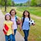 Children kid girls walking to schoool with sport balls