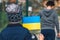 Children or kids with luggage, suitcase or bag, winter clothes, hat and Ukrainian flag