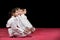 Children in kimono sitting on tatami on martial arts seminar. Selective focus