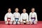 Children in kimono sitting on tatami on martial arts seminar. Selective focus