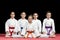 Children in kimono sitting on tatami on martial arts seminar. Selective focus