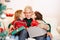 Children kissing grandfather with gifts on christmas