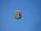 Children kite in the form of multicolored ship flying on sky background.