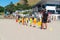 Children learning basics of fitness with Mount Maunganui Surf Life Saving Club on Main Beach on hot summer day