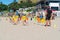 Children learning basics of fitness with Mount Maunganui Surf Life Saving Club on Main Beach on hot summer day