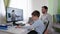 Children learning online, parent helps his son learn lessons uses modern technology for distance education sitting at