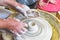 Children learning to make pottery as a hobby with their grandmother in a ceramics workshop