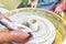 Children learning to make pottery as a hobby with their grandmother in a ceramics workshop