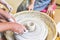 Children learning to make pottery as a hobby with their grandmother in a ceramics workshop