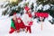 Children with letter to Santa at Christmas mail box in snow