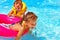 Children in life jacket in swimming pool.