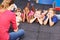 Children listening to story from book in kindergarten