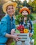 Children little girl holding mom a basket of fresh organic vegetables with the home garden.