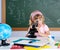 Children little girl at school with microscope