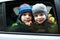 Children look out of car window