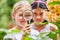 Children looking at flowers with magnifying glass
