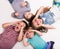 Children lying on the floor with hands imitating glasses