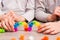 Children made two rainbows on the table from the details of colored sticky mosaics. Leisure of the child in confinement.