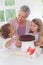 Children making cake with granny