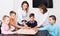 Children making move on pre-marked surface of board game