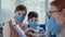 children medical health care, doctor and masked patients during consultation in hospital, therapist writes to clipboard