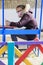 Children in medical mask and with phone on colored playground during quarantine