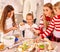 Children with mom cooking rolling dough in