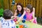 Children With Mom Dyeing Easter Eggs Outside