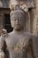 Children Monkey standing playing on ancient Buddha head statue, Candid animal wildlife picture waiting for food, group of mammal