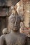 Children Monkey standing playing on ancient Buddha head statue, Candid animal wildlife picture waiting for food, group of mammal