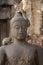 Children Monkey standing playing on ancient Buddha head statue, Candid animal wildlife picture waiting for food, group of mammal