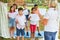 Children with music sheets sing together in a choir