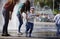 Children near a splashing fontain in the center of town