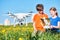 Children operating of flying drone at sunset