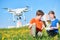 Children operating of flying drone at sunset