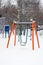 Children orange swing in snow