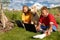 Children outdoors with laptops