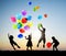 Children Outdoors Playing Balloons Together