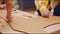 Children paint cardboard giraffe with markers on table