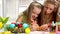 Children paint Easter eggs at home.