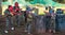 Children paintball players of opposite teams playing in shootout outdoors