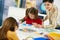 Children painting in art class at elementary school